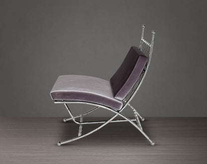Lounge chair upholstered in fabric with high polished stainless steel frame in bamboo design.