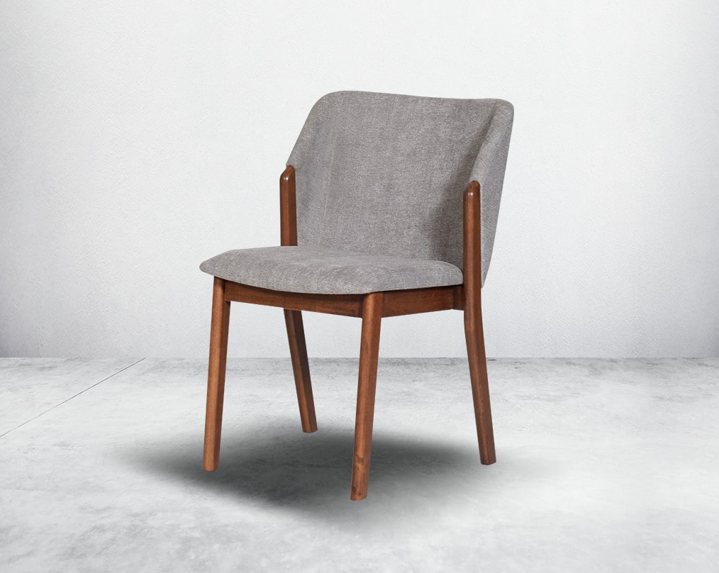 Dining chair upholstered in fabric with legs in walnut representing a sleek and modern style.
