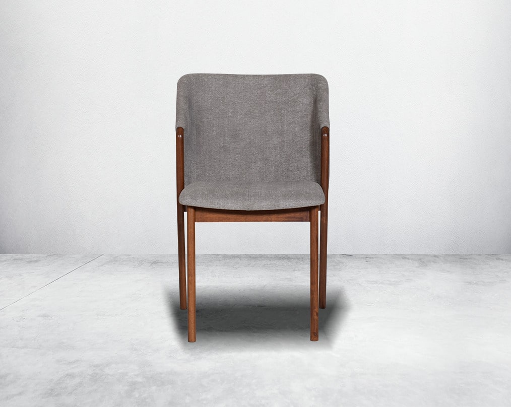 Dining chair front with upholstered in fabric with legs in walnut representing a sleek and modern style.