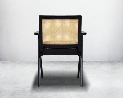 This appealing solid wooden dining chair with back  comfy cushioned seat & rattan backrest with curved armrest & geometrical leg design in dark walnut finish in retro style.