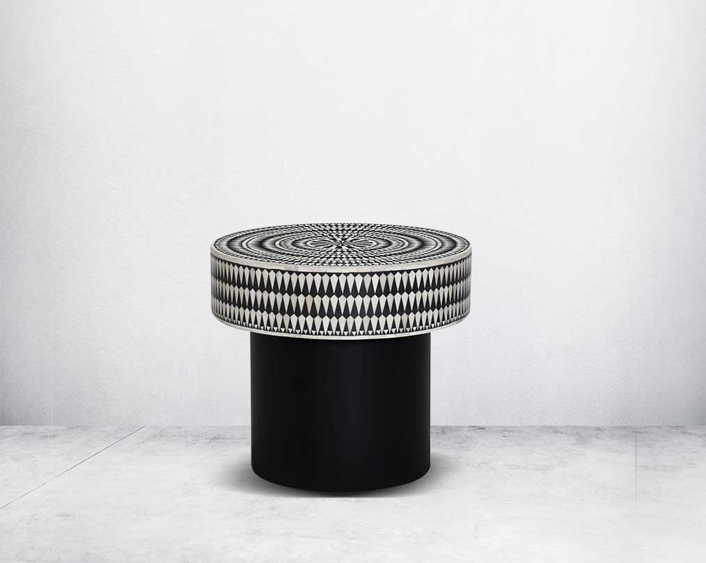 This gorgeous black and white inlay end table with a black metal base is a perfect statement piece in your living room.