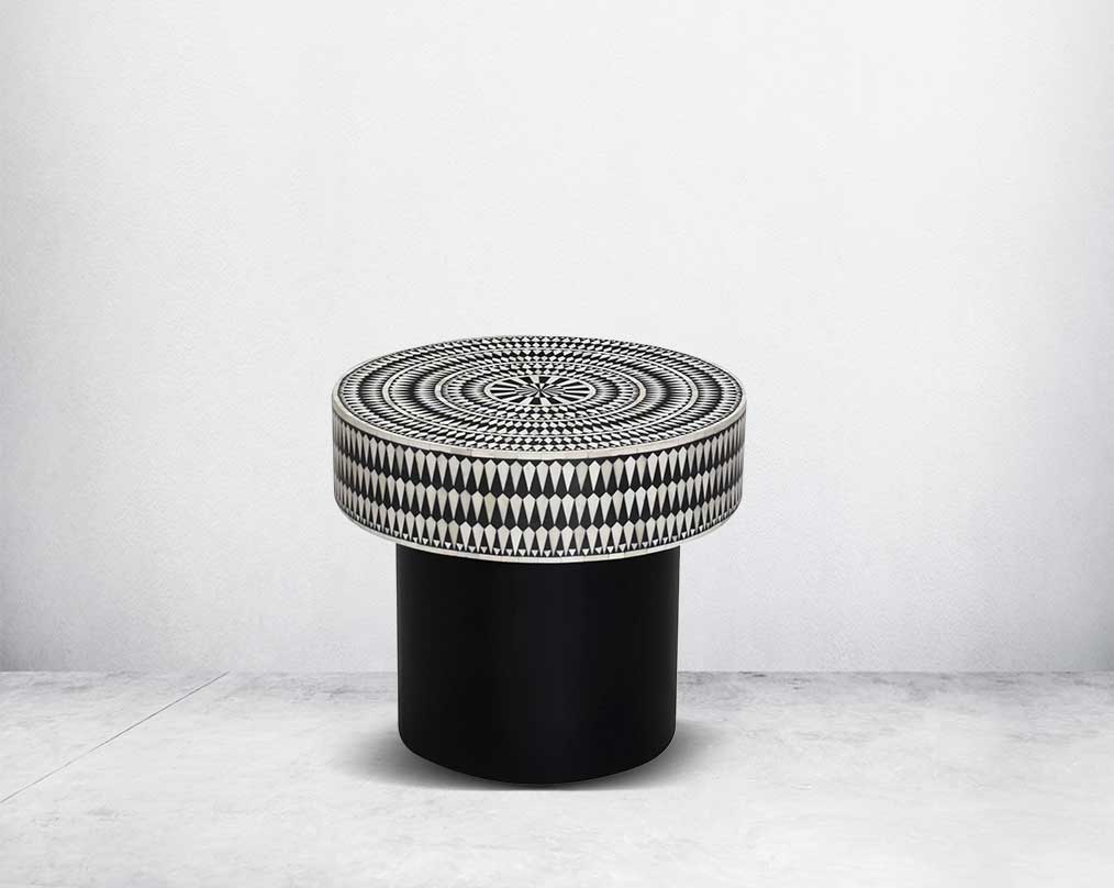 This gorgeous black and white inlay end table with a black metal base is a perfect statement piece in your living room.