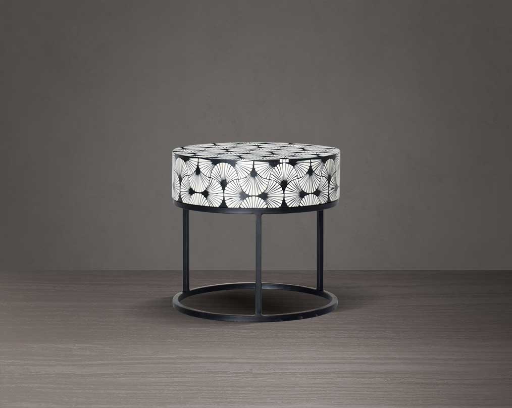 This gorgeous black and white inlay end table in floral pattern with a black metal base is a perfect statement piece in your living room.