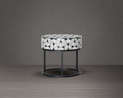 This gorgeous black and white inlay end table in floral pattern with a black metal base is a perfect statement piece in your living room.