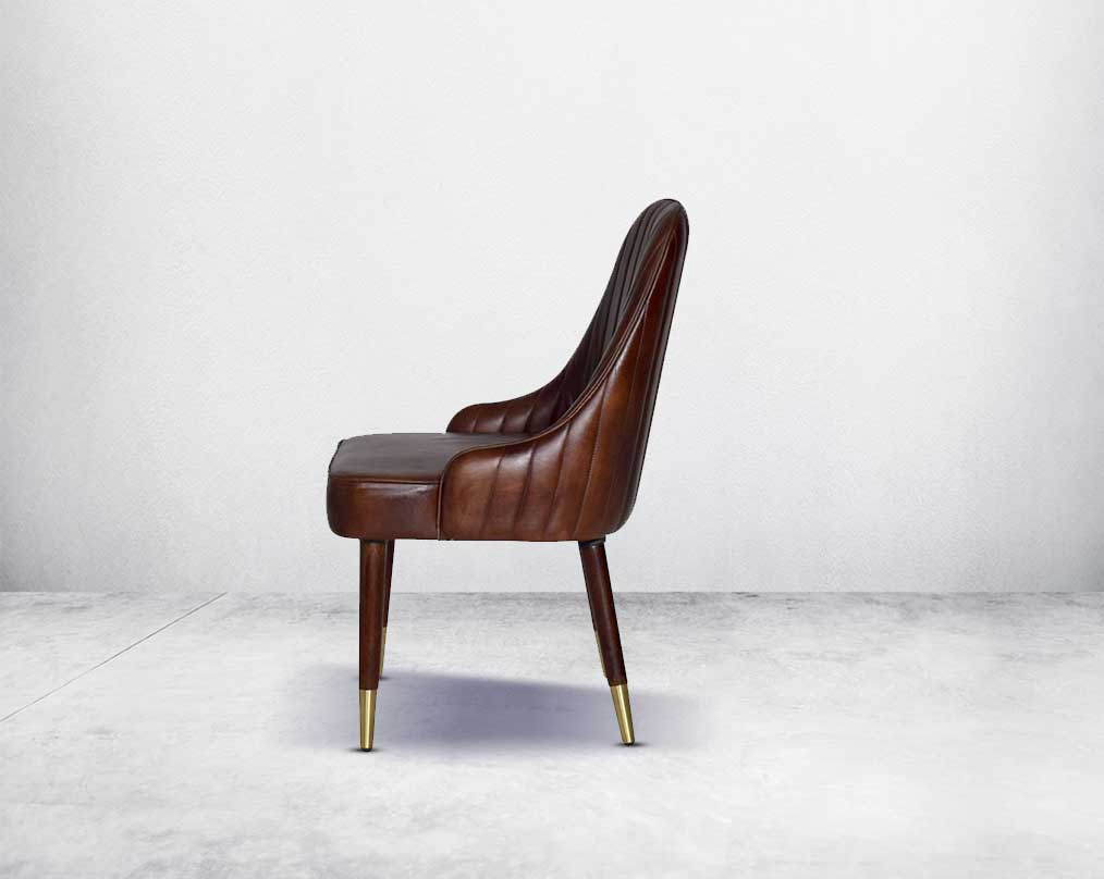 This rich contemporary dining chair in genuine leather makes for a luxurious dining experience. It comes with a quilted cushioned back in acacia wood with metal splayed legs.