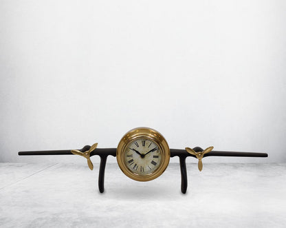 This unique vintage airplane propeller table clock comes with the clock in the center of the wings. This antique clock is made out of brass in antique matt finish. It has a white dial with Roman Numerals for a vintage look. This is a great statement piece
