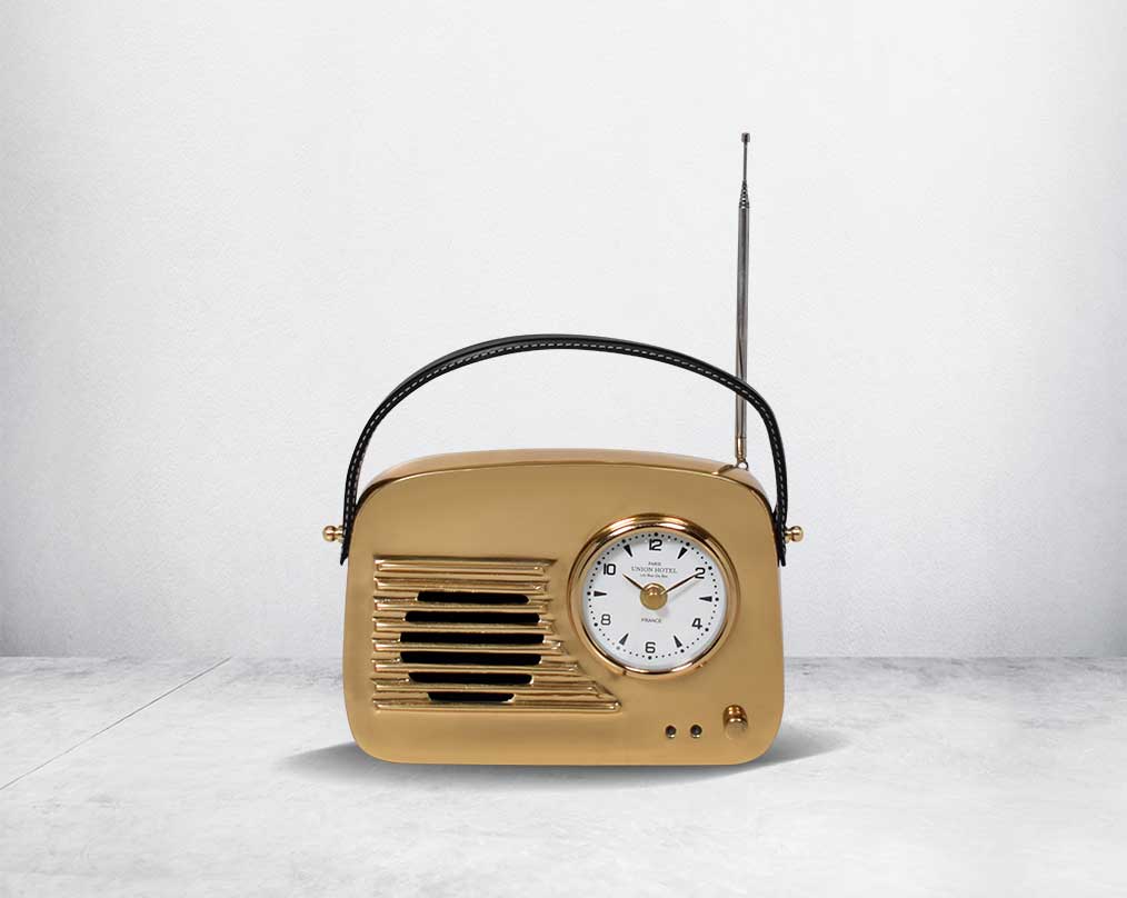This unique retro table clock is sure to make a statement in any home. It is crafted in antique brass. Has a functional cock in vintage radio design. It has a leather strap hence easy to move around.