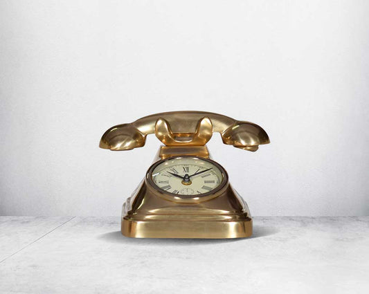 This unique vintage telephone table clock comes with a clock in the centre. This antique clock is made out of brass in an antique matt finish