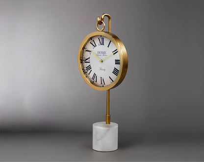 Round clock suspended on a hook in glossy gold & white marble base.