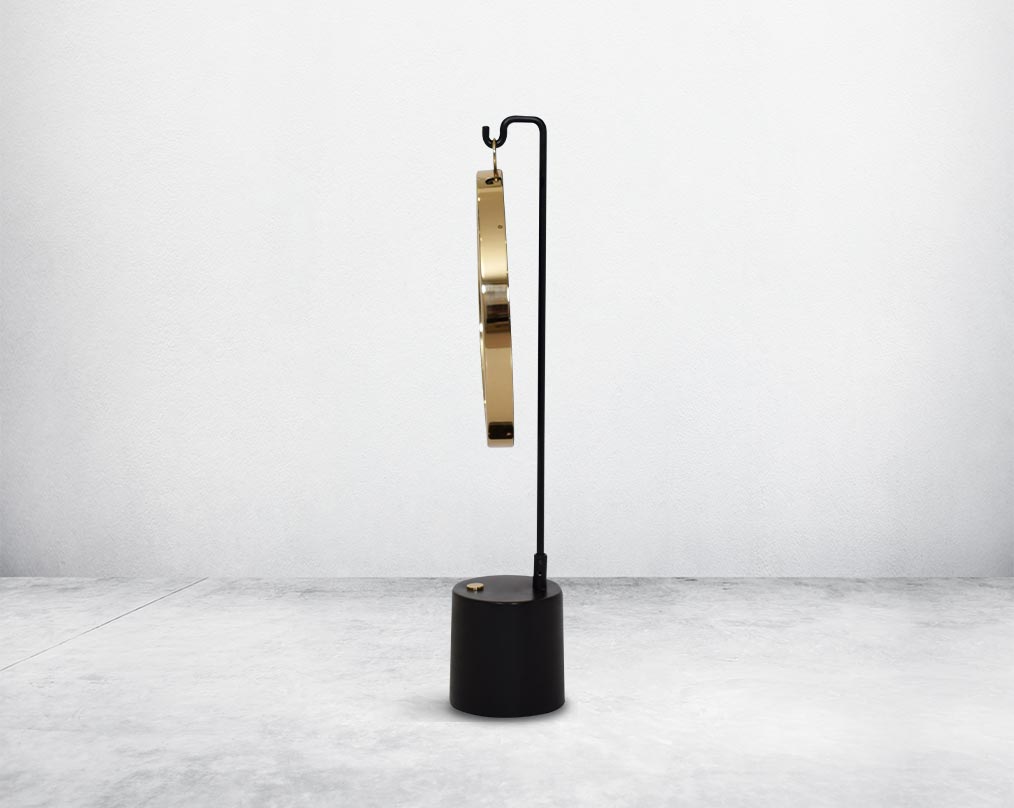 Round table dresser band mirror  suspended on a hook in shiny antique brass & matt black finished base. The look is very retro modern.