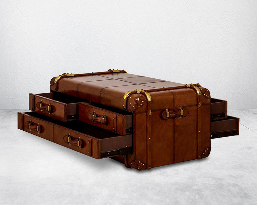 Coffee table in distressed cognac leather in a vintage open  4 drawer look It comes with storage and 1 drawer in trunk design.