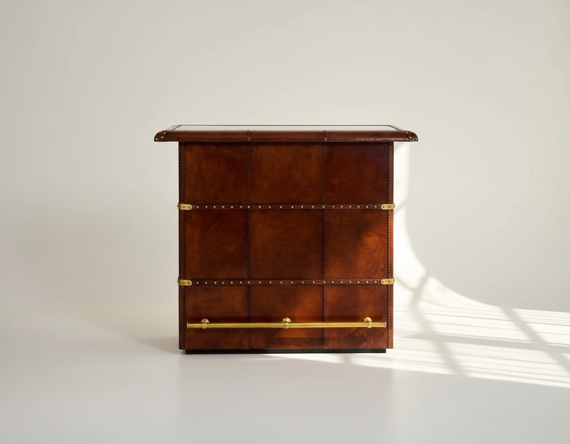 Bar counter in distressed cognac leather with a vintage look with brass hardware and wooden slats The bar counter has a copper top and comes with storage.