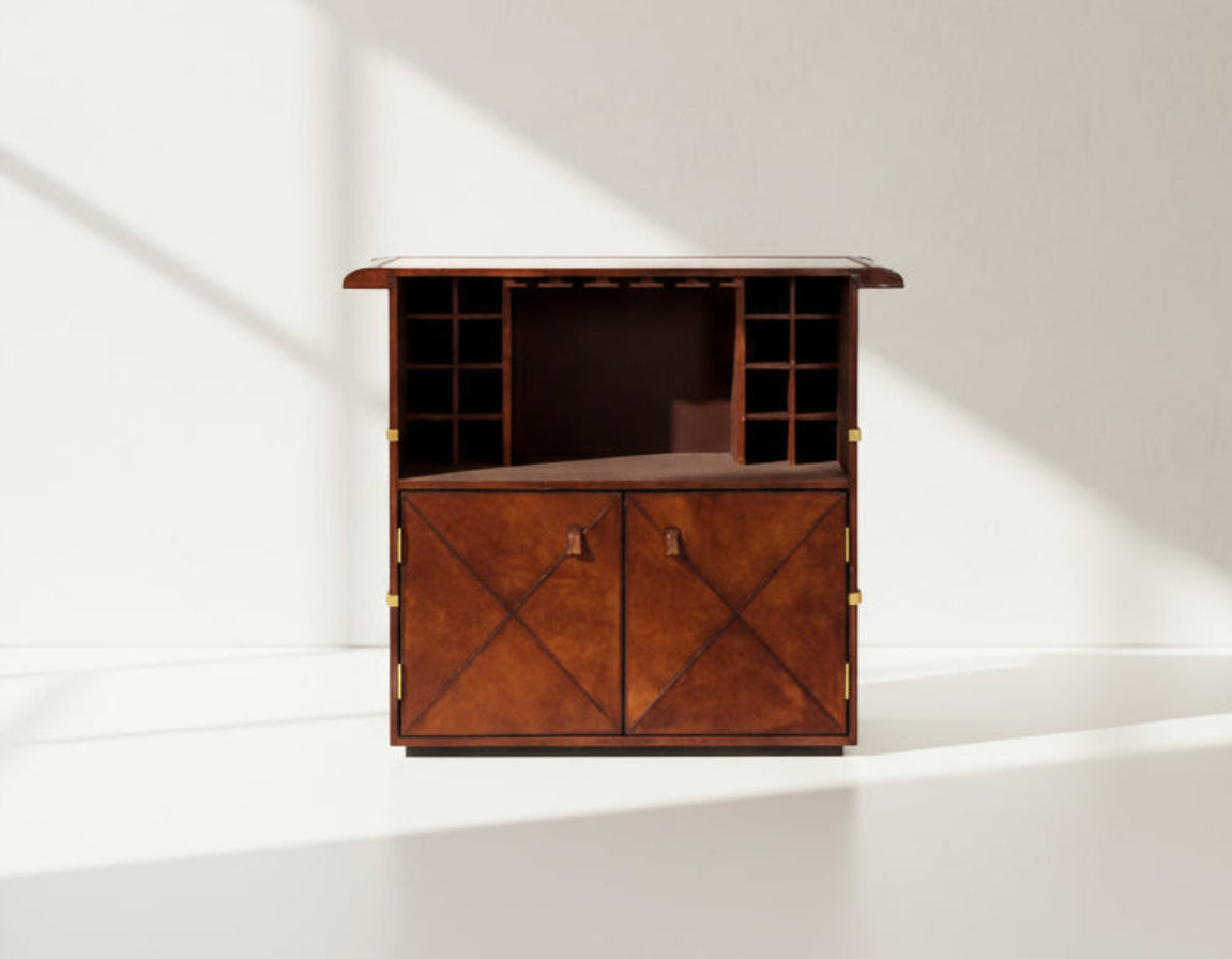 Bar counter open in distressed cognac leather with a vintage look with brass hardware and wooden slats. The bar counter has a copper top and comes with storage.