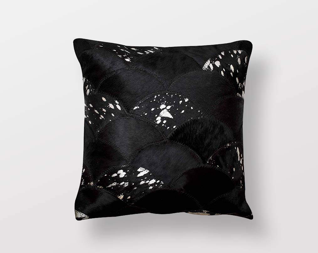 Black and silver hair on a leather cushion.