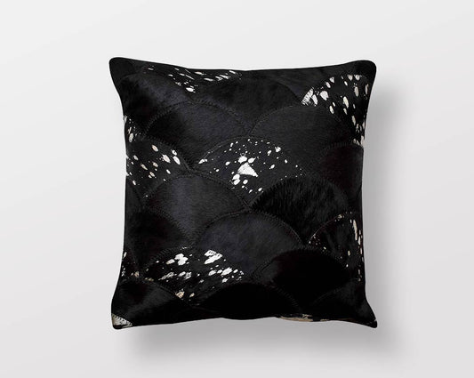 Black and silver hair on a leather cushion.