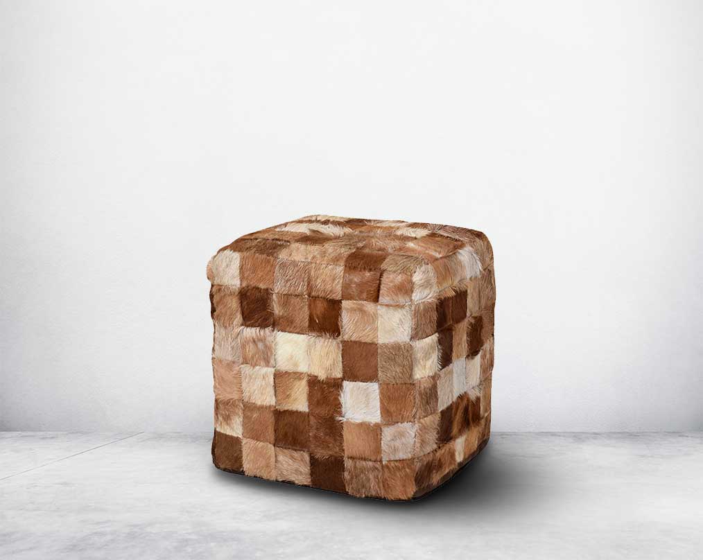 This square-shaped brown pouffe is crafted from wood and wrapped in genuine hair-on cutout leather in diff shades of brown which gives a rich contemporary look to any modern space.