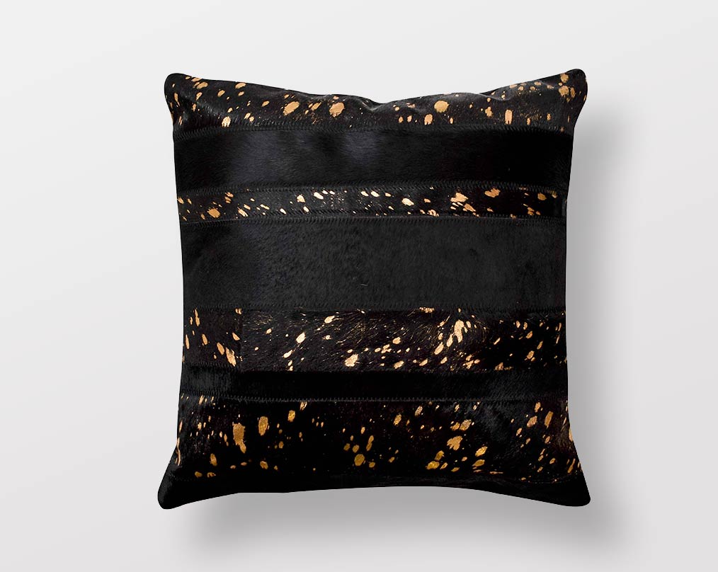 Black and copper hair on a leather cushion.