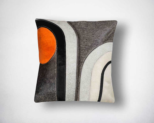 Grey, white, black & orange hair on a leather cushion