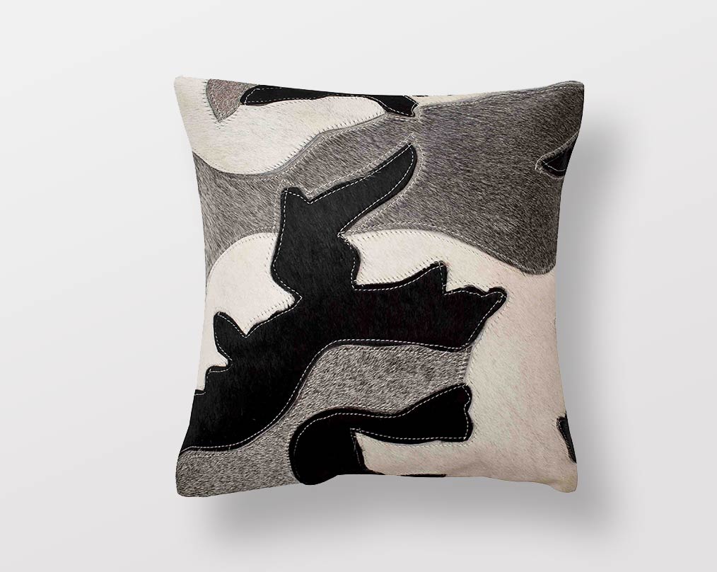 Black, white & grey hair on a leather cushion.