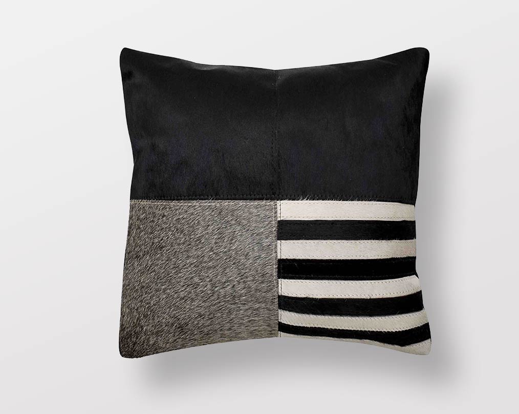 White, black & grey hair on & leather cushion.