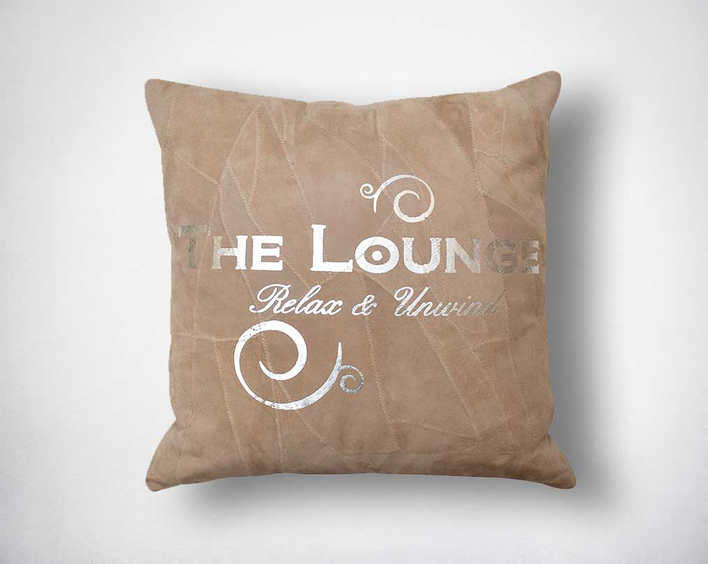 Leather cushion with silver foil print.