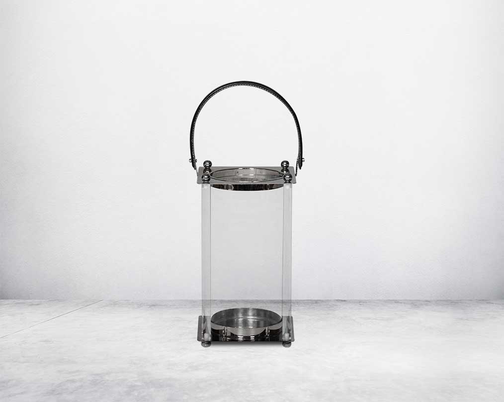 This lantern is crafted from leather, glass, and stainless steel and is perfect for adding aesthetic warmth and conviviality in any nighttime outdoor space. small