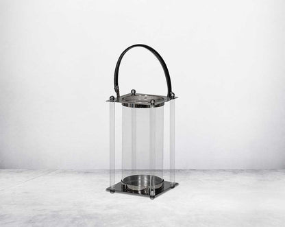 This lantern is crafted from leather, glass, and stainless steel and is perfect for adding aesthetic warmth and conviviality in any nighttime outdoor space. large