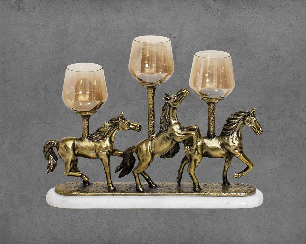 This vintage rearing three horses pillar candle holder in a light antique gold rustic finish with brown