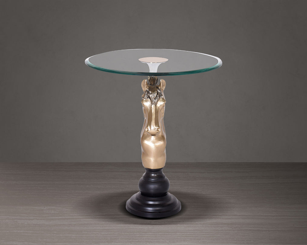 This vintage end table in gold finish aluminium base with horse head design motif