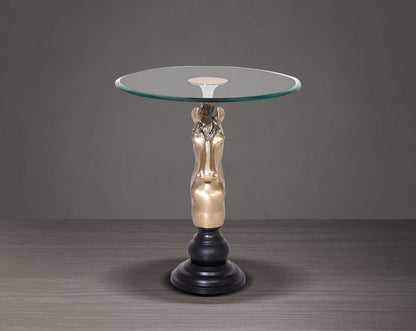 This vintage end table in gold finish aluminium base with horse head design motif
