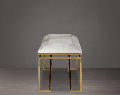 Double bench upholstered in light grey hide seat and high polished gold stainless steel legs in a contemporary, cross design.