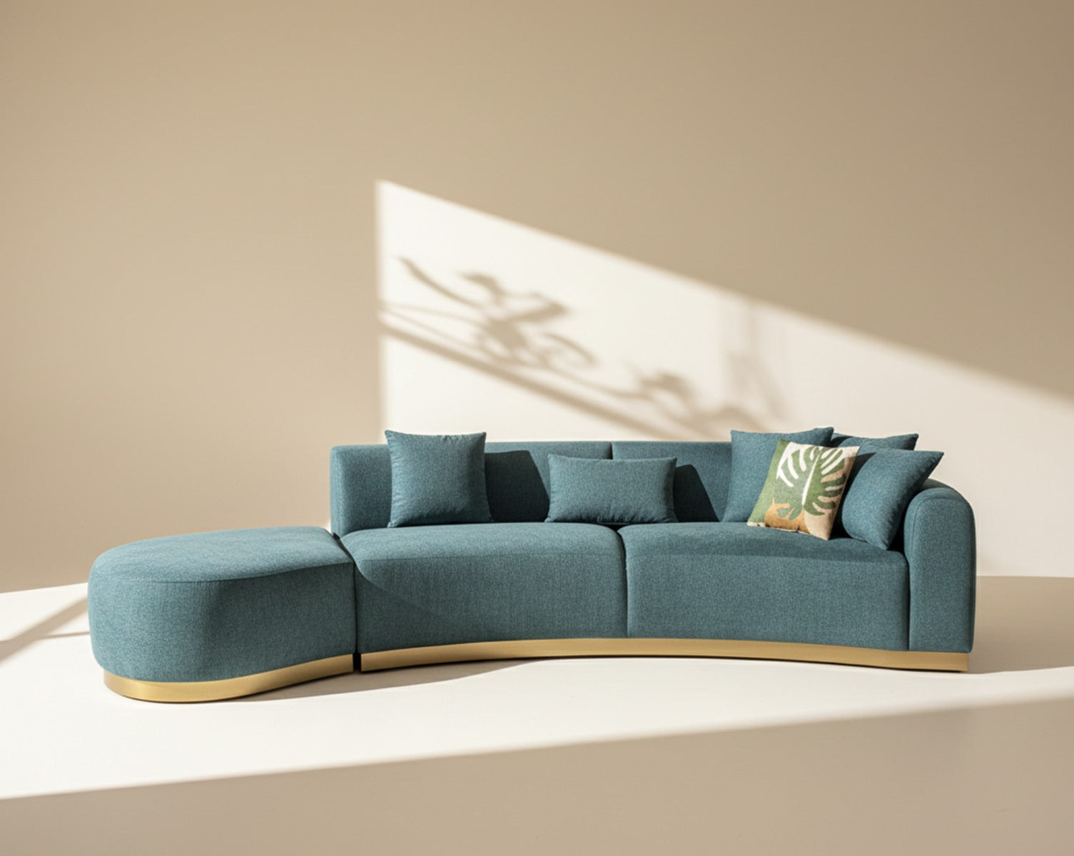 Modern teal sofa with decorative pillows on a beige background