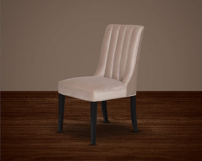 This quilted backrest dining chair in velvet fabric exudes timeless comfort and sophisticated beauty. The frame is constructed of solid wood to ensure lasting strength and stability. Perfect for a casual or formal dinner soirée.
