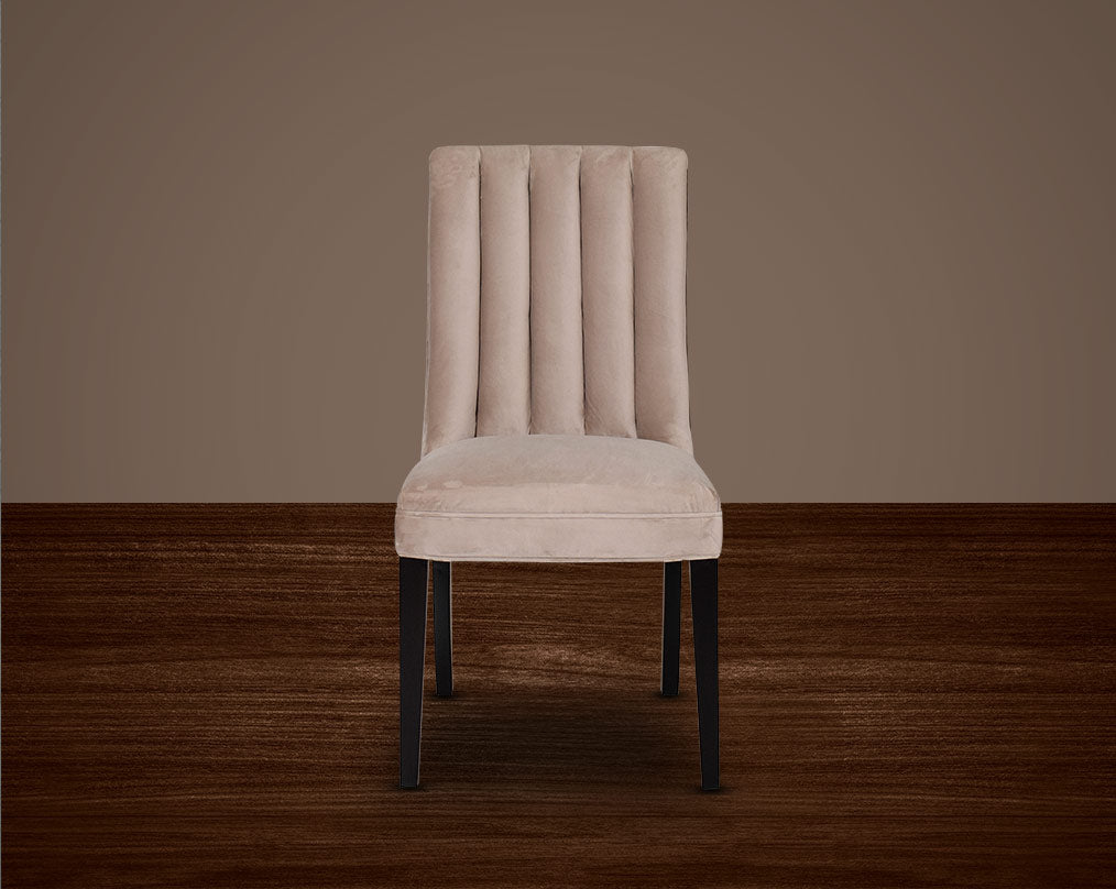 This quilted backrest dining chair front with in velvet fabric exudes timeless comfort and sophisticated beauty. The frame is constructed of solid wood to ensure lasting strength and stability. Perfect for a casual or formal dinner soirée.