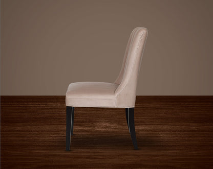 This quilted backrest dining chair in velvet fabric exudes timeless comfort and sophisticated beauty. The frame is constructed of solid wood to ensure lasting strength and stability. Perfect for a casual or formal dinner soirée.
