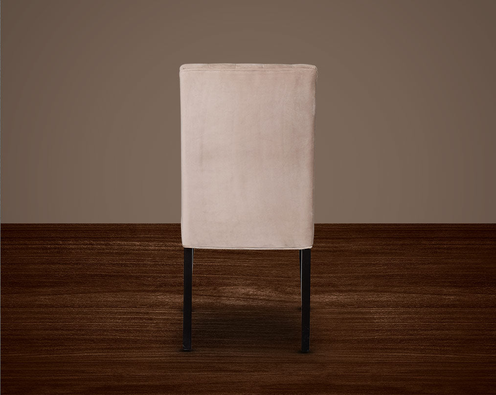 This quilted backrest dining chair back with in velvet fabric exudes timeless comfort and sophisticated beauty. The frame is constructed of solid wood to ensure lasting strength and stability. Perfect for a casual or formal dinner soirée.