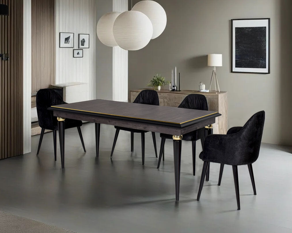 6 seater rectangular dining table in dark oak finish with an antique gold rim in wooden legs in modern classic design Dining chair black colour upholstered in fabric with legs in wood.