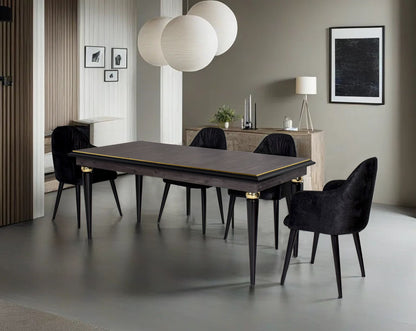 6 seater rectangular dining table in dark oak finish with an antique gold rim in wooden legs in modern classic design Dining chair black colour upholstered in fabric with legs in wood.