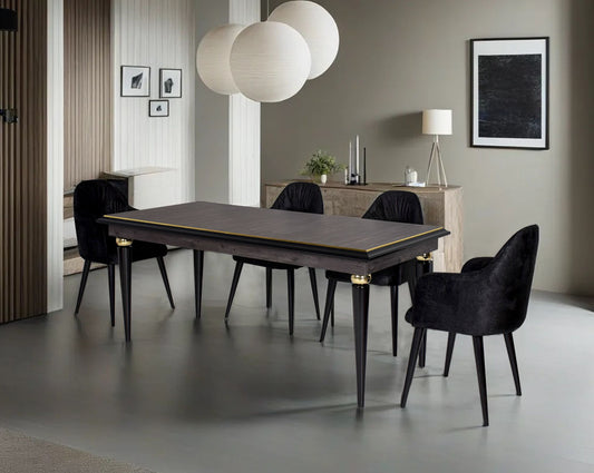 6 seater rectangular dining table in dark oak finish with an antique gold rim in wooden legs in modern classic design Dining chair black colour upholstered in fabric with legs in wood.