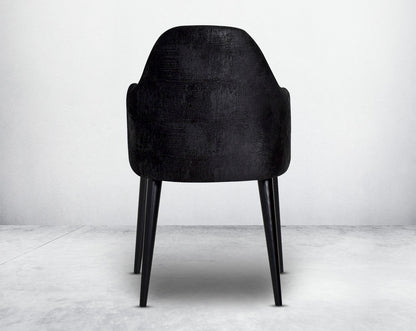 Dining chair upholstered in fabric with back view legs in wood.