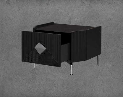 The gorgeous bedside table is in a black glossy finish with a spacious open  drawer with stainless steel handle & base.