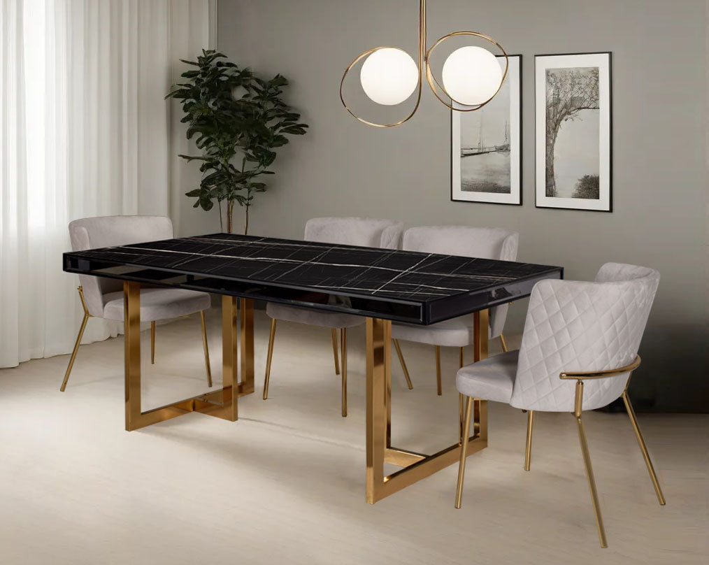 This 6-seater dining table comes with a black imitation Italian marble top & mirror frame/border with a stainless steel gold finished base in modern design with chair criss-cross stitch padded fabric in gold finish stainless steel legs in contemporary des