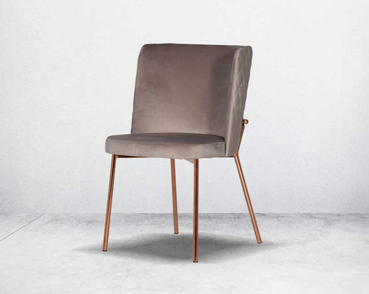 Minimalistically designed chair with criss-cross stitch padded fabric in rose gold finish stainless steel legs in contemporary design.