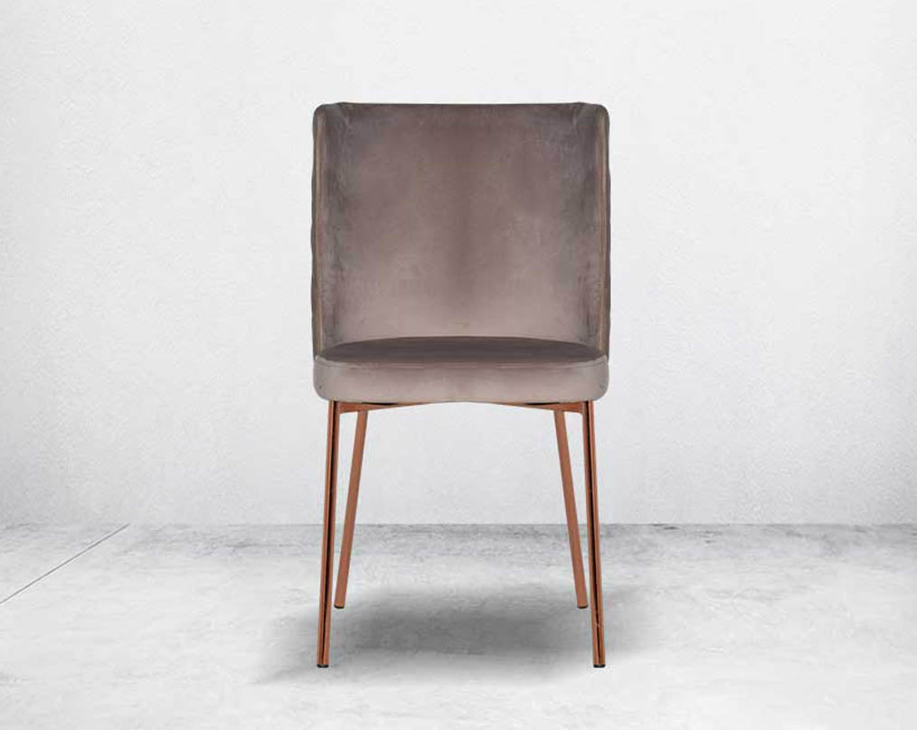 Minimalistically designed chair  front with criss-cross stitch padded fabric in rose gold finish stainless steel legs in contemporary design.