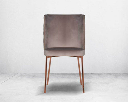Minimalistically designed chair  front with criss-cross stitch padded fabric in rose gold finish stainless steel legs in contemporary design.