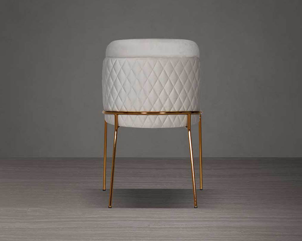 designed chair with back view criss-cross stitch padded fabric in gold finish stainless steel legs in contemporary design.