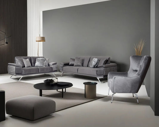 This elegant and sophisticated sofa upholstered in fabric with clean lines, straight shelter arms softened by subtle curves in modern classic design. Horizontal channel quilting is an outstanding design detailed with high gloss stainless steel base. The b