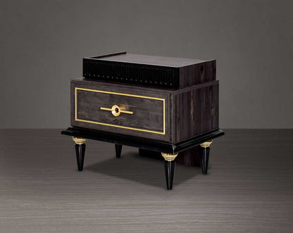 Bedside table in dark oak finish with antique gold design motif and two drawers with golden handles in modern classic design.