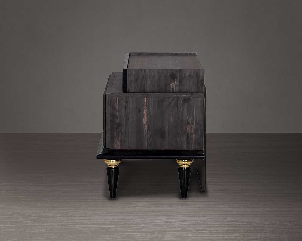 Bedside behind table in dark oak finish with antique gold design motif and two drawers with golden handles in modern classic design.