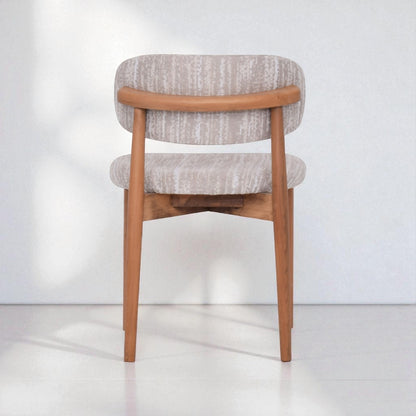 Chair with wooden frame and patterned cushion on a white background
